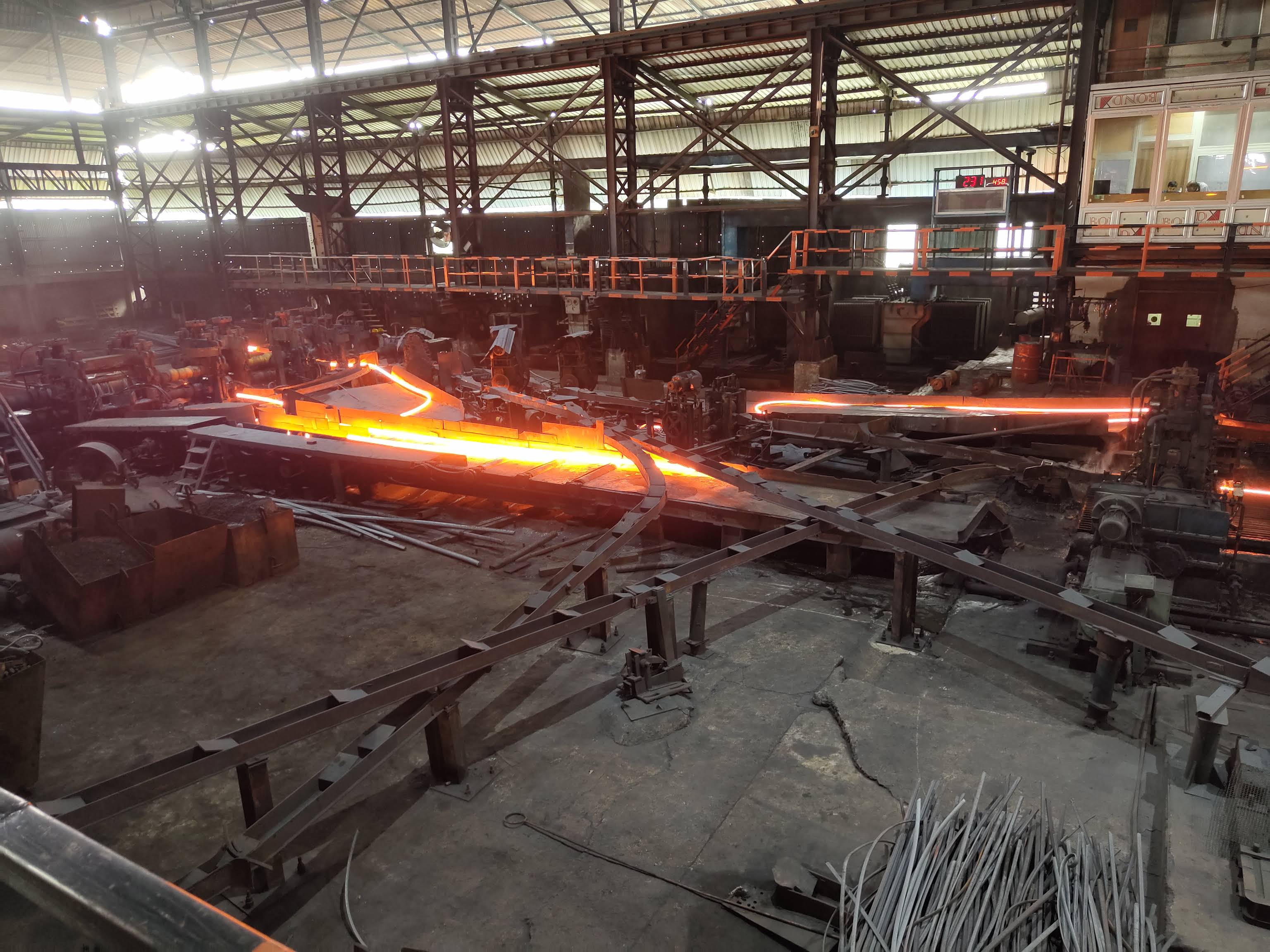 Hot rolling mill — glowing steel in motion